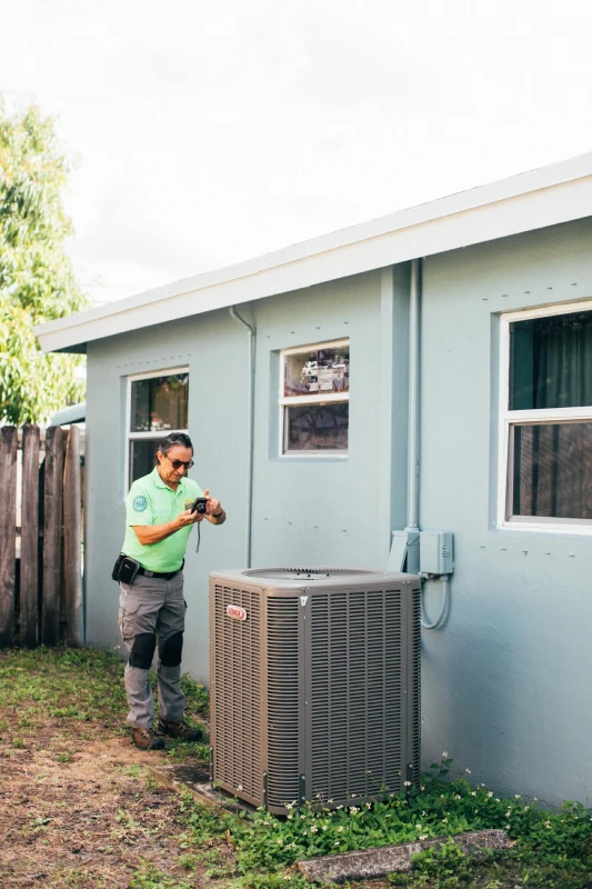 Certified 4 Point - Inspector evaluating an outdoor HVAC unit to ensure proper functionality and efficiency as part of a Four Points Inspection.