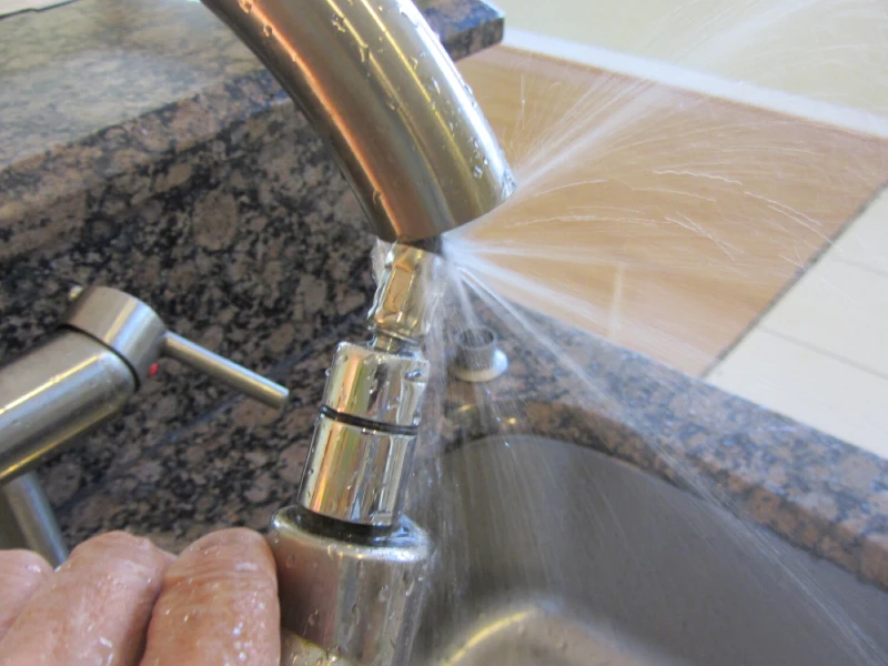 Certified 4-Point inspection, Close-up of a leaking kitchen faucet being inspected for plumbing issues during a Four Points Inspection service.