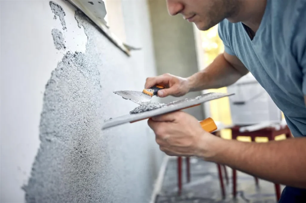 Professional assessing drywall cracks looking for Chinese drywall signs, during home inspection.