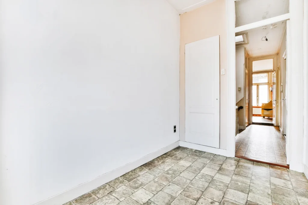 Empty room with tiled floor and white walls, representing the importance of lead testing for safe residential spaces.